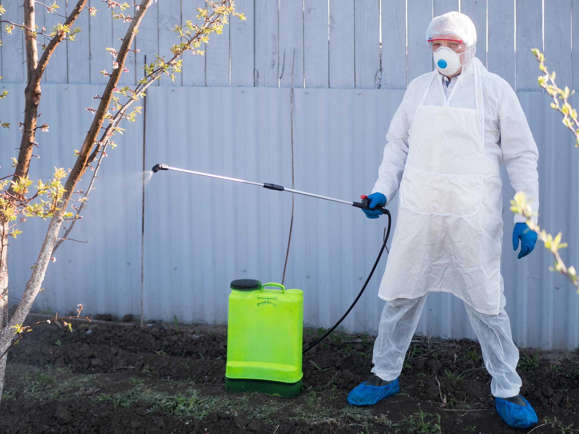 Elderly,Man,In,White,Protective,Clothing,With,Glasses,And,Working